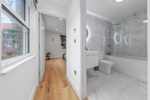 a white bathroom with a sink and a toilet at Brand new Apartment near London Bridge LR1 in London