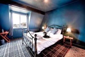 um quarto com uma cama num quarto azul em The Victoria Hotel em Scarborough