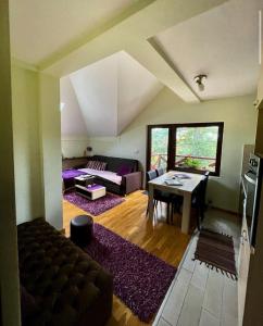 a living room with a couch and a table at Apartman Bianca in Palisad