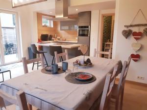 een keuken en eetkamer met een tafel en stoelen bij B&B Caprice d'Epices in Francorchamps