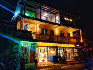 a building with a balcony on top of it at night at #1 Green Room Inn Siargao in General Luna