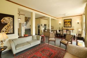 a living room with a couch and a dining room at Lamrin Norwood Green Palampur, Himachal Pradesh in Pālampur