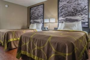 two beds in a hotel room with two beds at Super 8 by Wyndham Downtown Gatlinburg at Convention Center in Gatlinburg