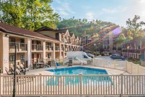 a hotel with a swimming pool in front of a building at Super 8 by Wyndham Downtown Gatlinburg at Convention Center in Gatlinburg