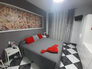 a bedroom with a bed with a red bird on it at A 50 metros de la playa in Cádiz
