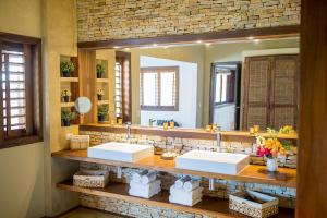 a bathroom with two sinks and a large mirror at Villa Alegria - La Villa Group in Jericoacoara +42 photos