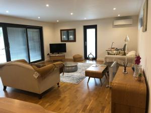 a living room with a couch and a tv at Independent rural detached annexe with free private Parking in Canterbury