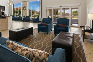 a waiting room with couches and chairs in a lobby at Comfort Suites in Granbury