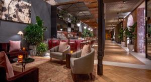 a lobby of a restaurant with chairs and a bar at The Eliza Jane, in The Unbound Collection by Hyatt in New Orleans
