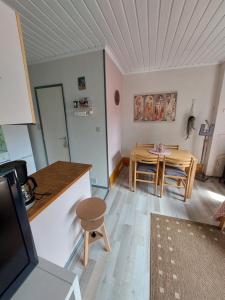 a kitchen and dining room with a table and chairs at LE PETIT CHALET - Bungalow in Waulsort