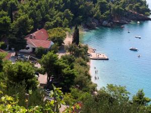 a beach in the middle of a body of water at APARTMENTS ON THE BEACH IN BAY MALA LUKA in Omiš