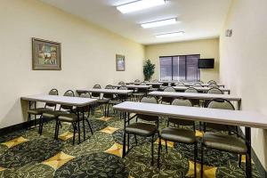 a classroom with tables and chairs in a room at Days Inn & Suites by Wyndham Houston / West Energy Corridor in Houston