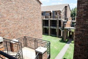 an image of a courtyard with a brick building at Eirini Elegant - Rispetto Apartment with Power Backup in Midrand
