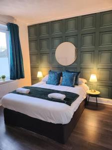 a bedroom with a large bed with blue pillows at Double King Bed Central Apartment by Property Promise in Cardiff