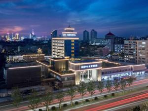 a city lit up at night with buildings at Novotel Nantong Center in Nantong