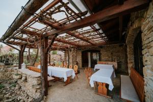 a patio with tables and chairs and a stone wall at penzion ROSETA in Radějov