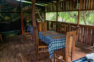 a dining room with a table and chairs in a cabin at Hotel Hideaway Garage in Dambulla