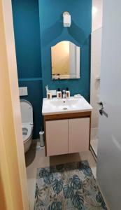 a bathroom with a sink and a toilet and a mirror at Matt & Sarah’s Cozy Family Duplex in Gudauri