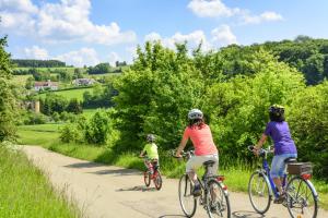 three people riding bikes down a dirt road at Ferienwohnung Bär in Vohenstrauß