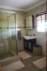 a bathroom with a shower and a sink at Lucca Lodge in Musina
