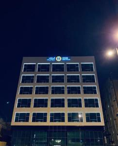 a building with a sign on the top of it at Iris Boutique Jazan in Jazan