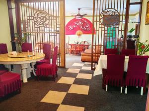 uma sala de jantar com uma mesa e cadeiras vermelhas em hongyuanprimierhotel em Accra