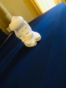 a figurine of a chef on top of a bed at Woodnest Summerside in Negombo