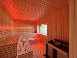 an empty sauna with red lights on the inside at Lerchenhof - Haus Kiebitz in Reestow