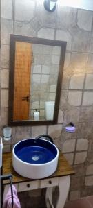 a bathroom with a blue sink and a mirror at Mí Santa Guadalupe Esquina ctes in Esquina