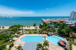 an aerial view of a resort with a pool and the beach at 3 BEDROOM SEAVIEW CONDO @ GLORY BEACH RESORT, PORT DICKSON in Port Dickson