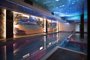 a swimming pool with a starry sky above it at Hotel Janów in Janów Lubelski