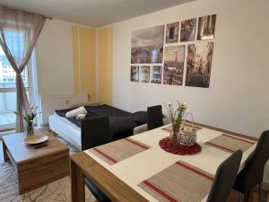 a living room with a table and a couch at Ferienwohnung Frühauf Rochlitz in Rochlitz +22 photos