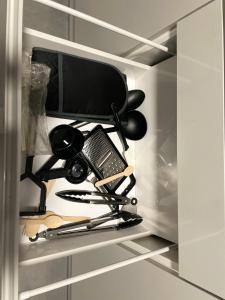 a drawer in a refrigerator filled with cooking utensils at Dinorwic Lodge in Liverpool