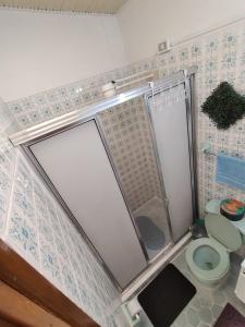 a small bathroom with a toilet and a shower at ZIPA HOSTEL in Zipaquirá