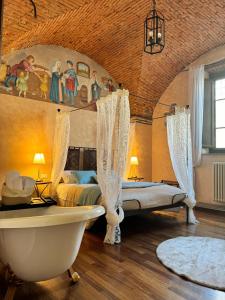 a bedroom with a bath tub and a bed and a bath tub at Luxury Corte dei Nobili in Lucca