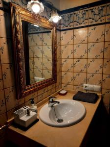 y baño con lavabo y espejo. en Casa Cotis Beceite en Beceite