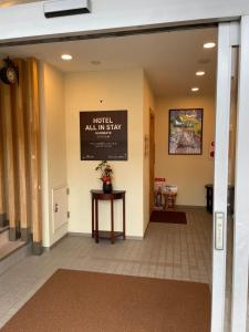 a lobby of a hotel with a sign on the wall at Hotel All In Stay Hakodate in Hakodate