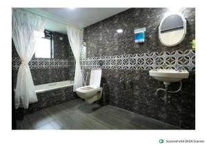 a bathroom with a sink and a toilet and a mirror at Exotica Villa in Lonavala +33 photos