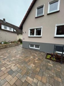 a house with windows and a brick driveway at Ferienhaus Harzglück in Bad Lauterberg