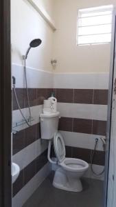 a bathroom with a toilet and a shower at GLG KLIA Transit House in Sepang