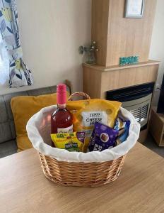 a basket of food and wine on a table at LottieLou’s Hot Tub breaks at Tattershall Lakes in Lincoln