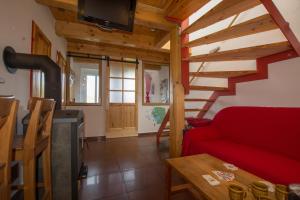 a living room with a red couch and a staircase at U Rožmberka Třeboňsko in Lužnice