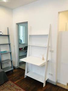 a room with white shelves and a mirror at The Studio Castle in middle of Fontainebleau in Fontainebleau