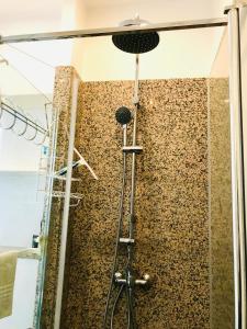 a shower in a bathroom with a stone wall at The Studio Castle in middle of Fontainebleau in Fontainebleau