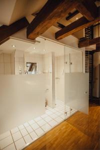 a large white bathroom with a glass shower at Hotel "Alter Pfarrhof" in Nabburg