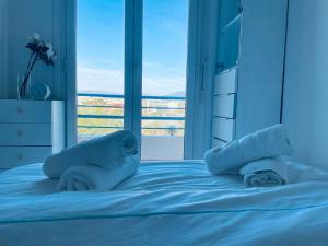 a bedroom with a bed with two pillows and a window at Luxury Apartment with amazing SEA view at Cap d'Antibes in Antibes