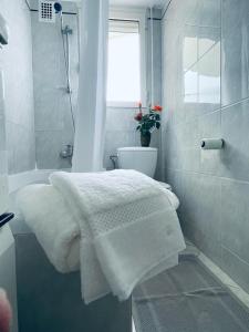 a white bathroom with a shower and white towels at Luxury Apartment with amazing SEA view at Cap d'Antibes in Antibes