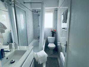 a white bathroom with a toilet and a sink at Luxury Apartment with amazing SEA view at Cap d'Antibes in Antibes