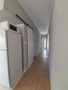 an empty hallway with a refrigerator and a microwave at Los Robles in Mercedes