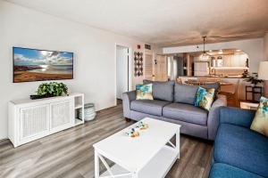 a living room with a couch and a table at Sand Castle 2901 in Clearwater Beach